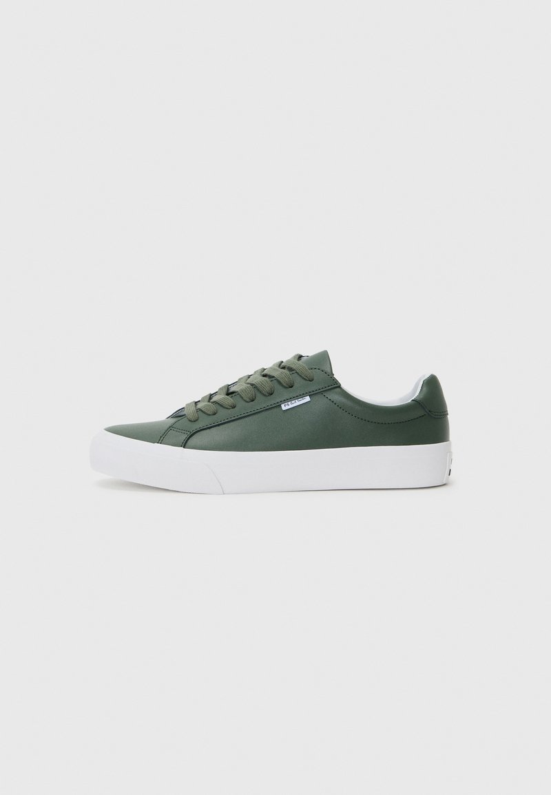 Green synthetic low-top sneaker with white rubber sole, round toe, six eyelets, and flat laces. Minimal branding on the side.