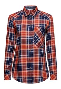 Chemise à manches longues boutonnée avec motif à carreaux rouge, marine et blanc et poche poitrine inclinée sur le côté gauche.
