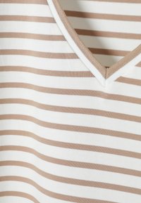 Tricou cu decolteu în V, stripeat, în nuanțe de bej și alb. Fabricat dintr-un material moale, cu dungi orizontale. Prezintă o textură netedă și margini finisate.