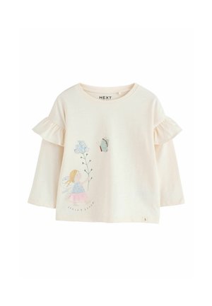 Krémově zbarvená košile s dlouhým rukávem a vrstvenými volánovými rukávy, s ilustrací víly a květin a textem "Jarní květ" ve spodní části.