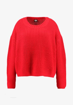 Priadza pletený pulóver v žiarivej červenej farbe. Má okrúhly výstrih, spadnuté ramená a textúrovaný vzor. Uvoľnený strih s dlhými rukávmi.