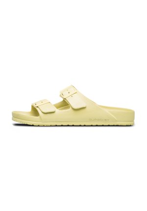 Light yellow slip-on sandals made of textured foam, featuring two adjustable straps with square buckles and a cushioned sole.
