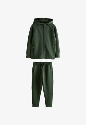 Grønne zip-hoodie med hætte og lynlåslommer, parret med matchende joggerbukser med elastisk talje og lommer.