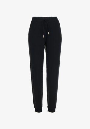 Pantalones de chándal negros hechos de un tejido suave, con una cinturilla elástica con cordón, bolsillos laterales y puños acanalados en los tobillos.