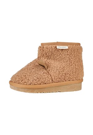 Beige, flauschiger Stiefel aus strukturiertem Material, mit runder Zehe, elastischem Bund und einem kleinen Lederakzent an der Seite. Gummisohle.