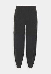 Pantaloni da jogger neri con vita elastica, gambe affusolate e tasche laterali con zip. Presentano un tessuto testurizzato con finitura opaca e il logo Nike.