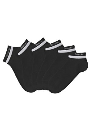 Six pairs of black ankle socks with white cuffs, featuring a logo on the cuff area. Made of a soft, stretchy fabric.