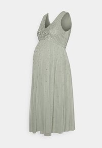 Vestido de maternidade em suave verde sálvia, com decote em V e corpete adornado com detalhes prateados. Saia pregueada que flui suavemente.