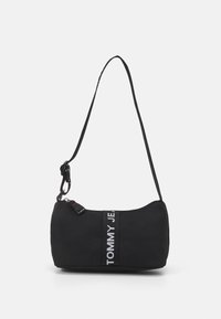 Black shoulder bag with a rounded shape and textured fabric. Features a white logo stripe and adjustable strap with a silver hardware clip.