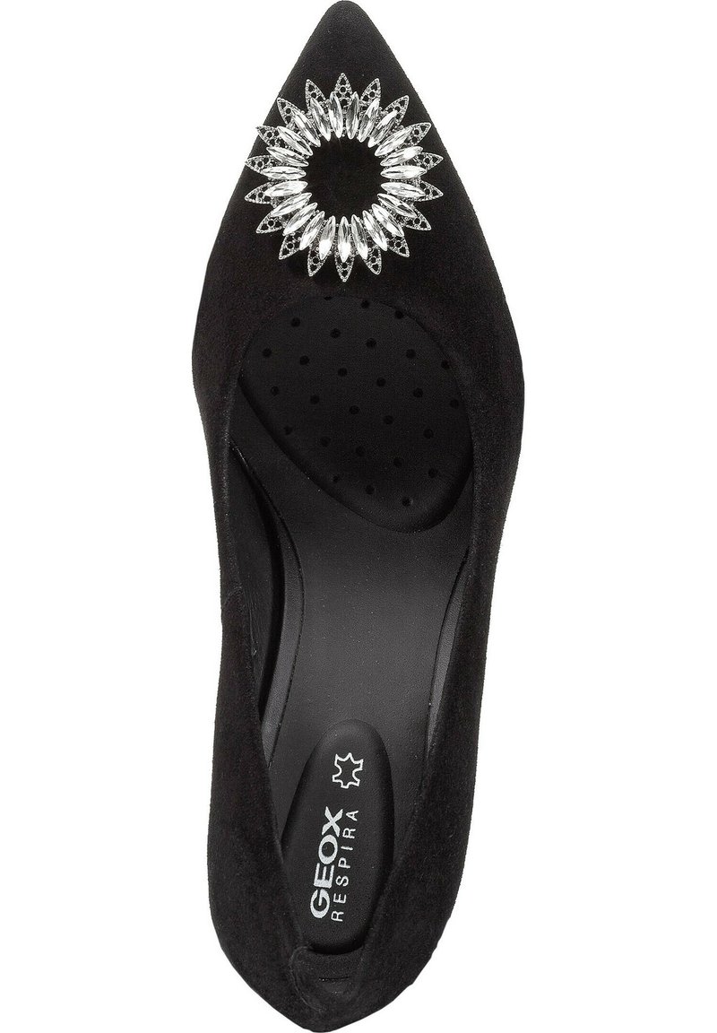 Scarpa ballerina nera a punta con texture in suede morbido e una decorazione di spilla floreale in cristallo argentato sulla parte superiore.