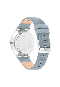 Montre en acier inoxydable argenté avec un bracelet en caoutchouc bleu clair, présentant des motifs en relief et une doublure en cuir lisse. Design résistant à l'eau.