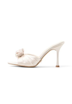 Satin high-heeled sandal in light cream, featuring a knotted embellishment and a sleek open-toe design. Stiletto heel with a brown accent.