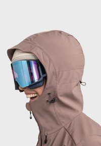 Brown hooded jacket with a sleek design, featuring adjustable drawstrings. Large blue-purple tinted goggles enhance visibility.