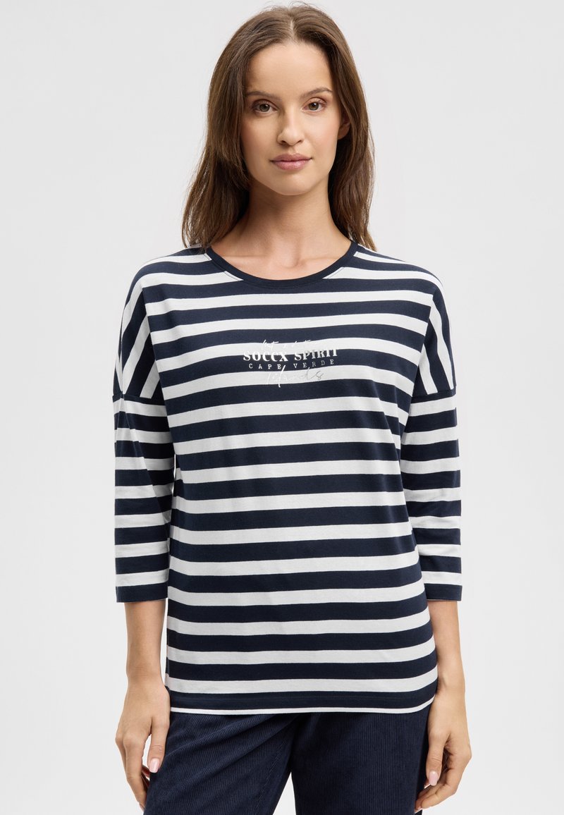 Navy and white striped long-sleeve top with a round neckline and "SOUCA SPIRIT CAPE VERDE" text printed on the front. Soft, lightweight fabric.