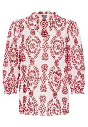 Blusa bianca con ricamo floreale rosso, scollo a V e maniche a sbuffo con polsini elasticizzati. Il motivo presenta intricate forme geometriche.