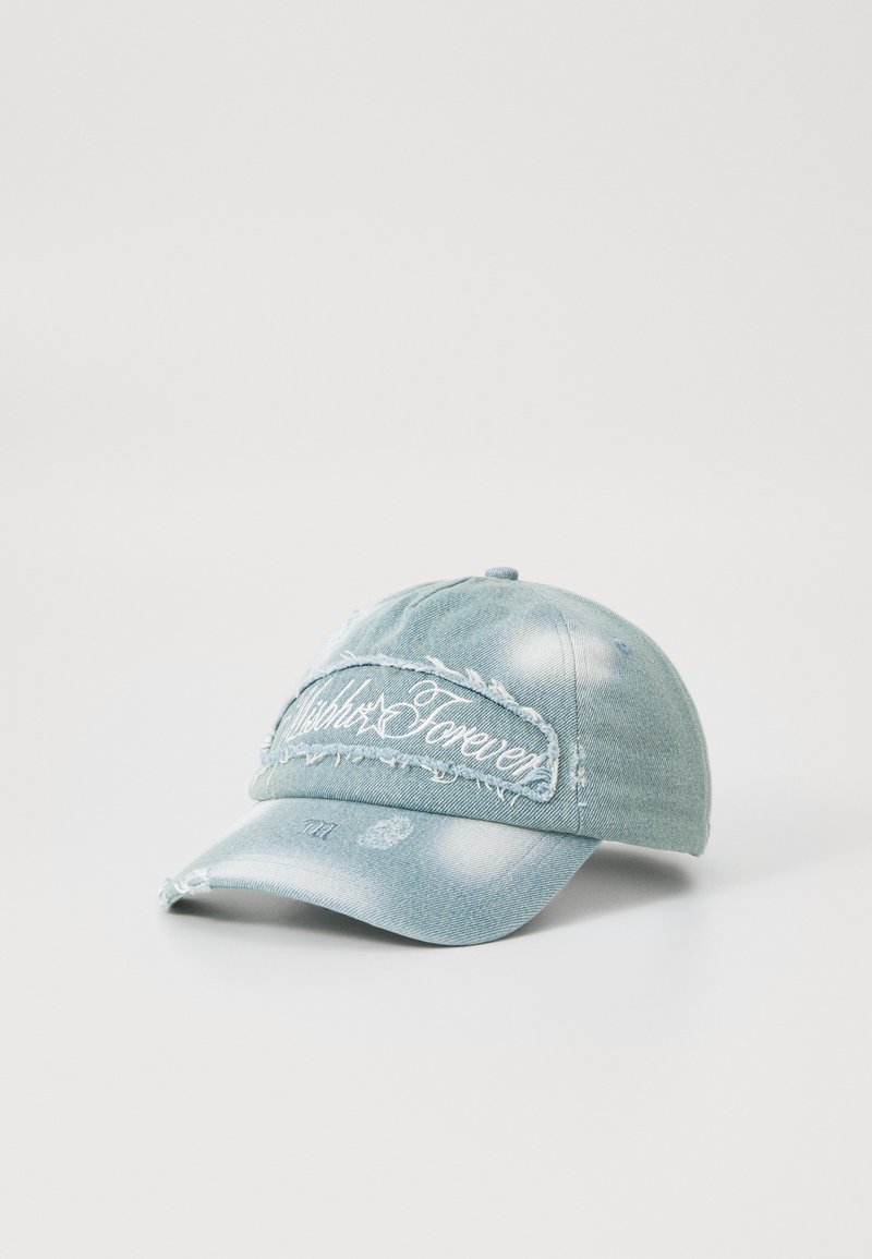 Denim cap in light blue with frayed accents and white embroidered text on the front. Features a curved peak and classic adjustable strap.