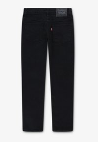 Black denim jeans with a straight cut, featuring two back pockets, a leather logo patch at the waist, and a slightly faded texture.