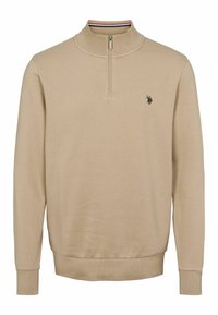 Béžový, ľahký sveter s polovičným zipsom a rebrovanými manžetami. Obsahuje malé logo na hrudi a štruktúrovanú tkaninu.