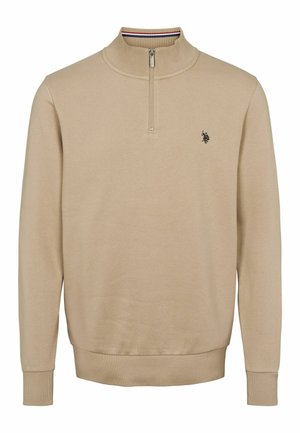 Bež, kerge sviiter, millel on pooltõmblukuga kaelus ja soonikkoes mansetid. Rinnal on väike logo ja tekstureeritud kangas.