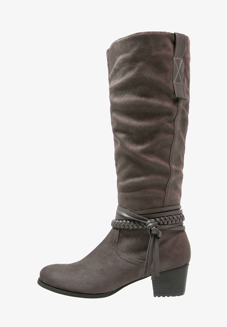 Botte haute en daim gris foncé avec un petit talon bloc, des brides tressées et lisses attachées autour de la cheville, et une languette de tirage en haut.