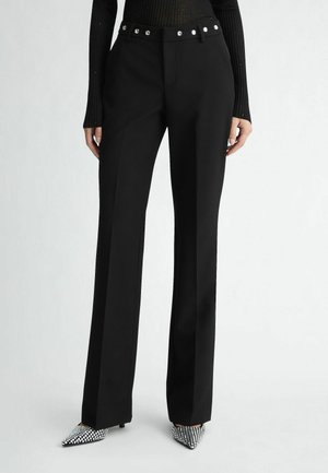 Black tailored trousers with a straight leg, featuring a high waist and silver button accents on the waistband. Smooth fabric, no patterns.