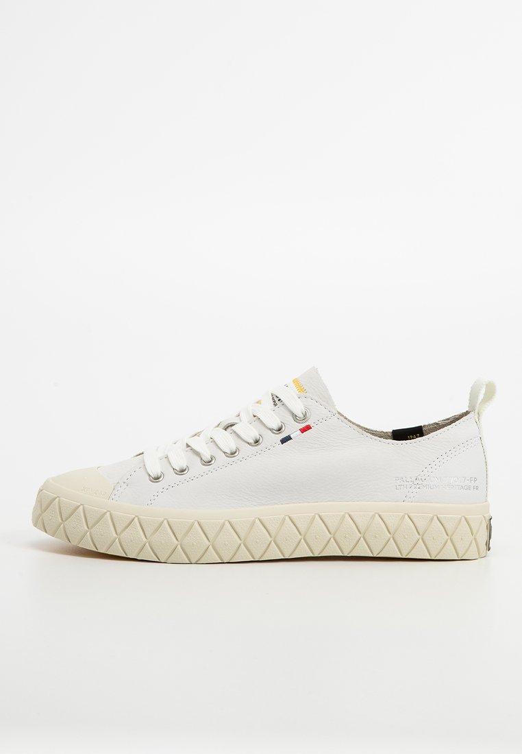 Vita lädersneaker med en texturerad gummisula, rund tå och snörningsdesign. Har röda, gula och blå detaljer på tungan.