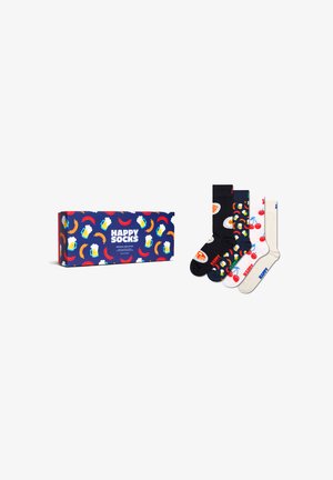 Vier bunte Socken mit Frühstücks- und Obstmustern neben einer passenden Geschenkbox mit der Aufschrift "Happy Socks" und Designs von Bier, Wurst und Chili.