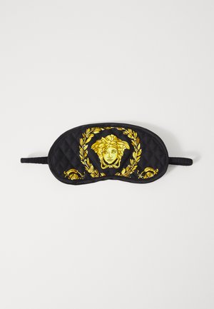 Must musträtiga une mask, millel on tikandiga tekstuur, millel on kuldne Medusa disain, mida ümbritseb lauriokste pärg ja dekoratiivsed elemendid.