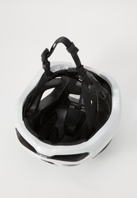Weißer Fahrradhelm von oben betrachtet, mit schwarzen Riemen und Lüftungsschlitzen. Innere Polsterung und Beschriftung sind sichtbar.