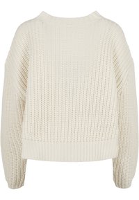 Pull en maille épaisse couleur crème avec manches longues, poignets, ourlet et encolure côtelés, présentant un motif tissé texturé.