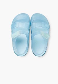 Light blue sandals made from flexible material, featuring adjustable straps and a textured surface for grip. Designed for comfort and easy wear.