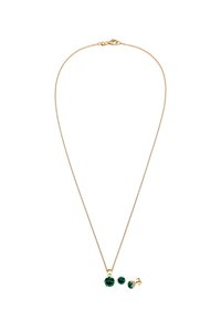 Collana dorata con tre accenti di cristallo verde di diverse dimensioni e chiusura a moschettone. Catena liscia con una finitura fine.