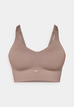 Soutien-gorge de sport doux, couleur taupe, avec une texture lisse. Il dispose de bretelles réglables et d'un logo Nike discret au centre.