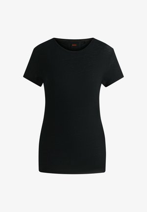 Musta lyhythihainen t-paita, joka on valmistettu kevyestä kankaasta. Siinä on pyöreä pääntie ja hienovarainen teksturoitu pinta. Bränditagi näkyvissä sisäpuolella.