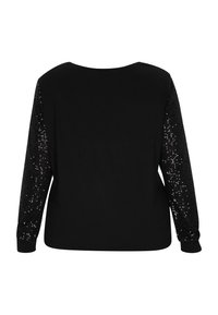 Top nero con maniche lunghe; corpo in tessuto liscio, maniche ricoperte di paillettes nere lucide, scollo rotondo e polsini a costine.