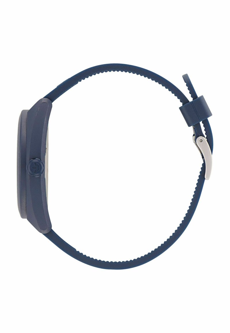 Orologio in silicone blu navy con quadrante rotondo, lunetta liscia e cinturino texturizzato. Presenta una fibbia in metallo e una corona pronunciata.