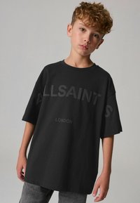 Must have sinine oversized t-särk, mis on valmistatud puuvillast, millel on julged "ALLSAINTS" ja "LONDON" tekst peenelt hallis toonis. Lühikesed varrukad ja ümar kaelus.