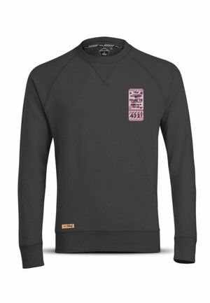 Zwarte sweatshirt met een ronde hals en raglanmouwen. Bevat een roze ticketafbeelding aan de voorkant en een klein geweven label aan de zoom.