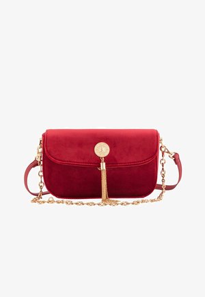 Red suede crossbody bag with a gold chain strap, featuring a tassel accent and a round clasp on the front. Smooth texture, rectangular shape.