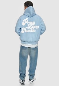 Dropsize HEAVY  PRAY LOVE HUSTLE - Kapuutsiga pusa - baby blue