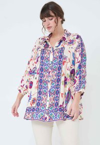 Multicolored floral patterned shirt with a button-down front, featuring blue and purple accents, and loose, airy design. Long sleeves.
