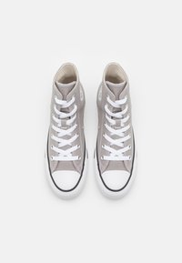 High-top sneakers in gray canvas with white laces, rubber toe cap, and black sole. Features eyelets and stitched accents.