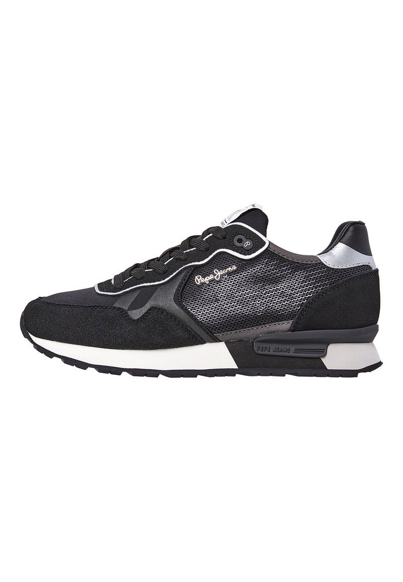 Black sneaker with mesh and suede upper, white outsole, silver accents, and black laces. Features logo on the side and a cushioned sole.