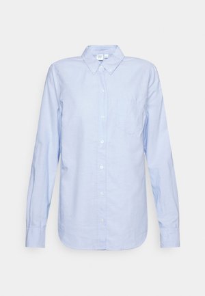Light blue long-sleeve button-up shirt with a pointed collar and chest pocket, displayed on a plain white background.