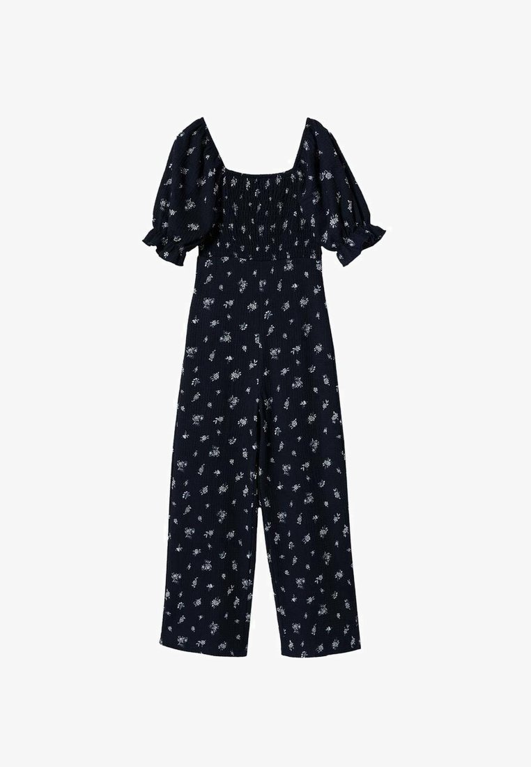 Combinaison bleu marine à imprimé floral blanc, col carré, manches bouffantes, corsage froncé et coupe à jambes larges pour une tenue décontractée.