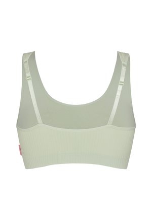 Lichtgroene naadloze bralette met verstelbare schouderbandjes en geribbelde elastische band, gezien vanaf de achterkant tegen een witte achtergrond.