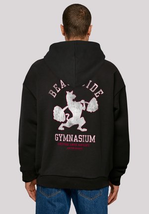 Black hoodie with a large gray graphic of a bear lifting weights. Text reads “BEACHSIDE GYMNASIUM” in red and white. Soft material, relaxed fit.