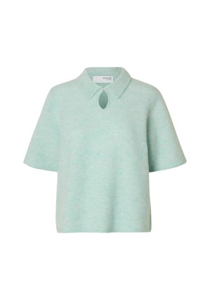 Mündiroheline lühikeste varrukatega kampsun krae ja kaelakaare detailiga kaelusel. Pehme, tekstuurse kangaga ja lahtise lõikega.