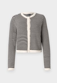 Cardigan nero e crema con un motivo a zigzag, scollatura tonda, maniche lunghe e cinque bottoni frontali. Tessuto lavorato a maglia, lunghezza cropped.