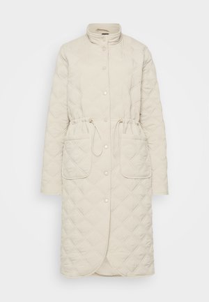 Quilted beige coat with a high collar, button closure, drawstring waist, and two front pockets. Features diamond-patterned textured fabric.